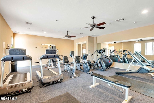 exercise room featuring visible vents and baseboards