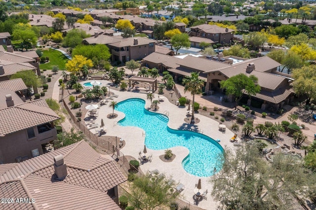 view of pool with a patio and a residential view