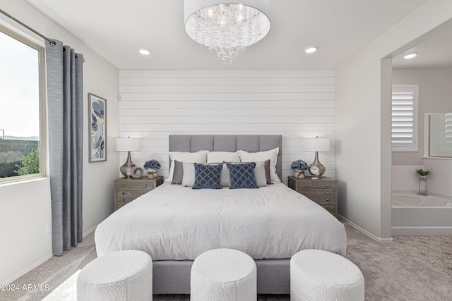 bedroom with light colored carpet and a chandelier