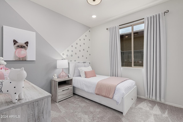 bedroom featuring vaulted ceiling and light carpet