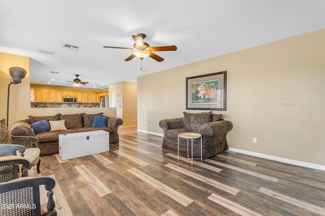 living room featuring ceiling fan and hardwood / wood-style floors