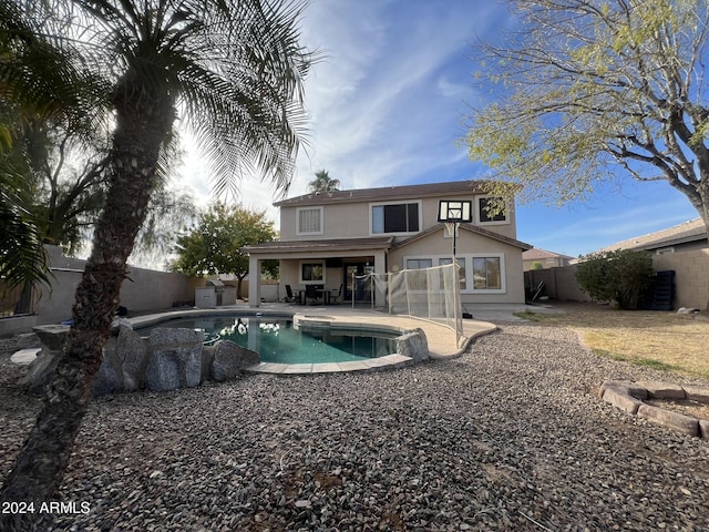 back of house featuring a fenced in pool and a patio