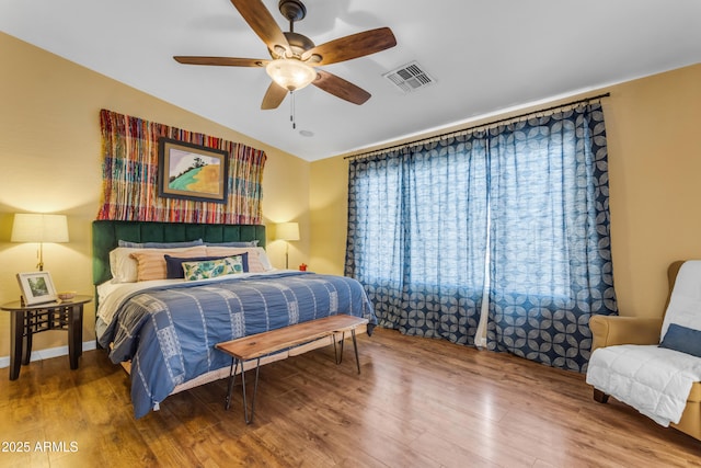 bedroom featuring ceiling fan, wood-type flooring, and vaulted ceiling