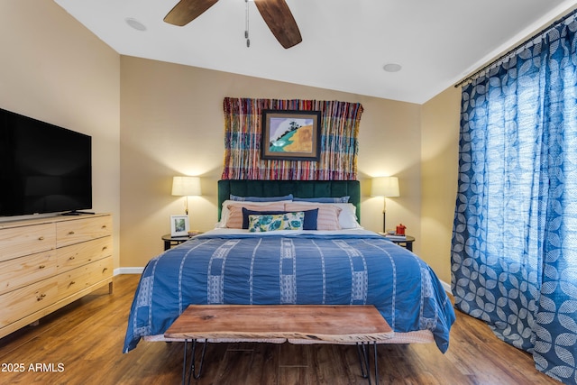 bedroom featuring ceiling fan, wood-type flooring, and vaulted ceiling