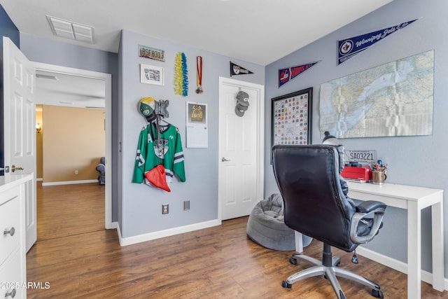 home office featuring lofted ceiling and dark hardwood / wood-style flooring