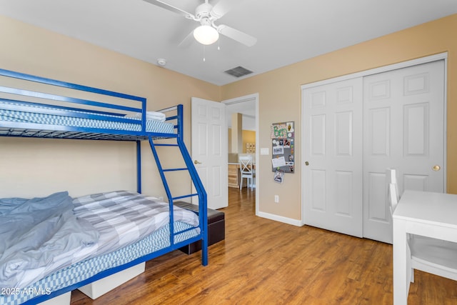 bedroom featuring hardwood / wood-style flooring, ceiling fan, and a closet