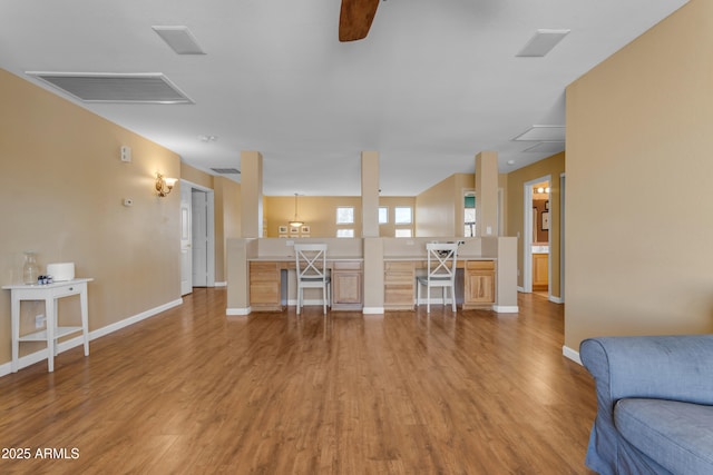 living room featuring ceiling fan and light hardwood / wood-style flooring