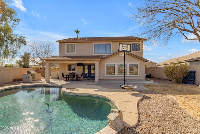 back of house with a patio area and a fire pit