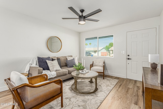 living room featuring ceiling fan and light hardwood / wood-style flooring