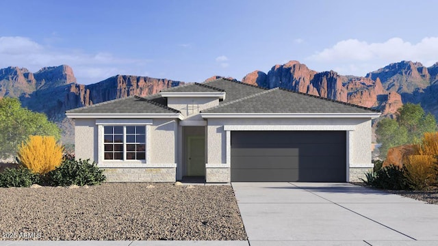 24052 W Pima St, Buckeye, AZ 85326 - ranch-style home featuring an attached garage, concrete driveway, a mountain view, stucco siding, and stone siding