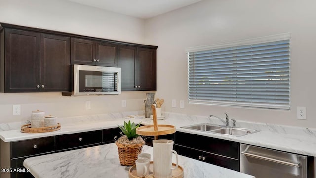 24052 W Pima St, Buckeye, AZ 85326 - kitchen with appliances with stainless steel finishes, dark brown cabinetry, and light stone counters