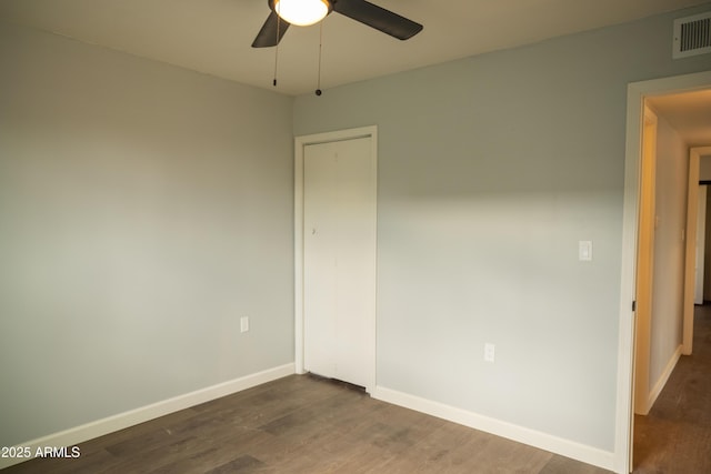 unfurnished room featuring ceiling fan and dark hardwood / wood-style floors