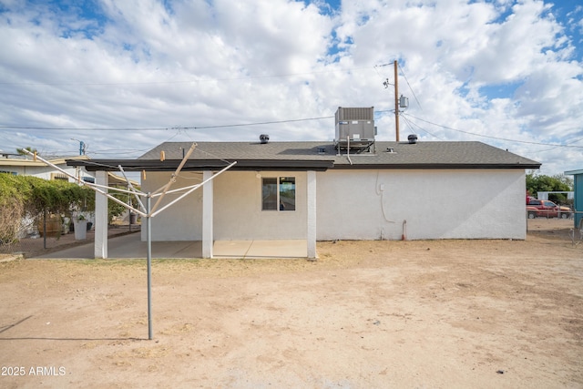 rear view of house with a patio and cooling unit