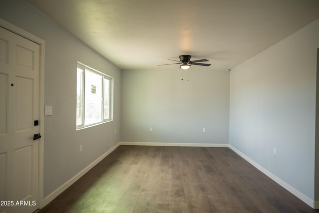 spare room featuring ceiling fan and dark hardwood / wood-style flooring