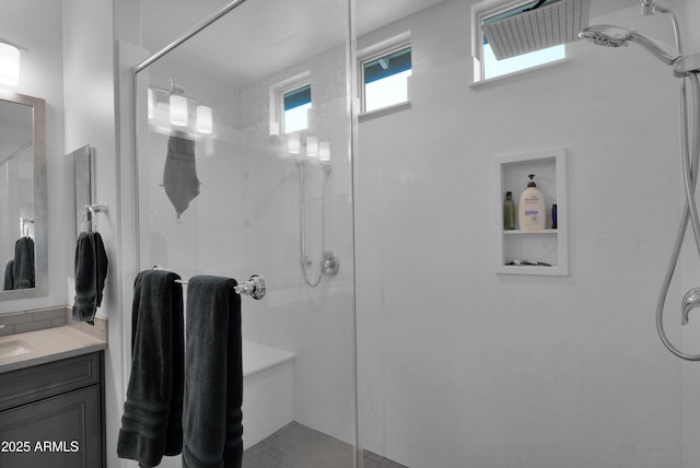 bathroom with a shower stall and vanity