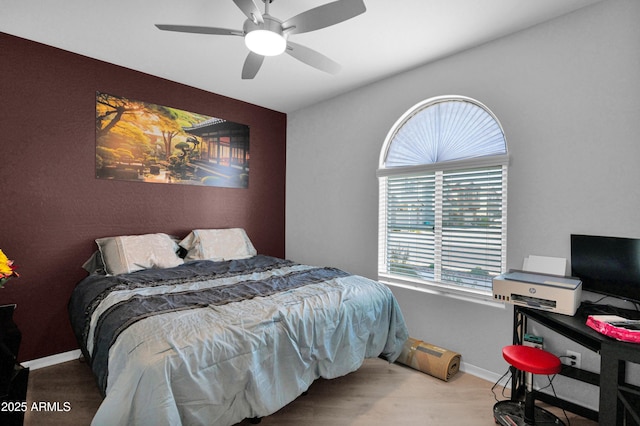 bedroom with wood finished floors, baseboards, and ceiling fan