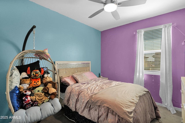 bedroom featuring ceiling fan, baseboards, and carpet