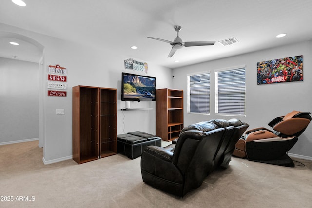 carpeted living area featuring visible vents, recessed lighting, arched walkways, baseboards, and ceiling fan