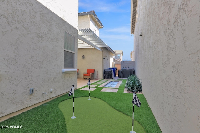 view of yard with fence, a pergola, and a patio area