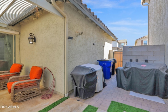 view of patio featuring area for grilling and fence