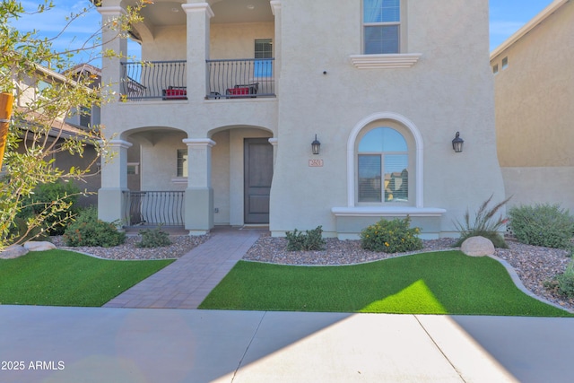 exterior space with a porch, a balcony, and stucco siding