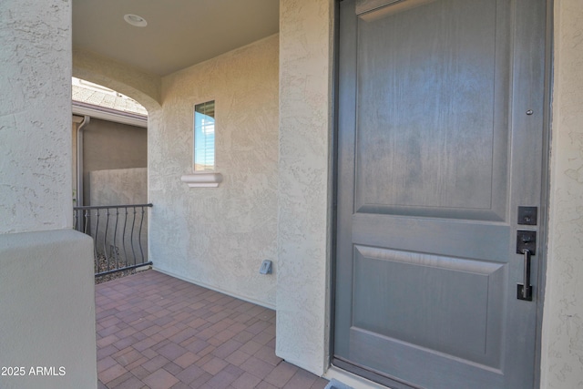 property entrance featuring stucco siding