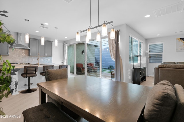 dining area featuring recessed lighting, visible vents, and light wood-style floors