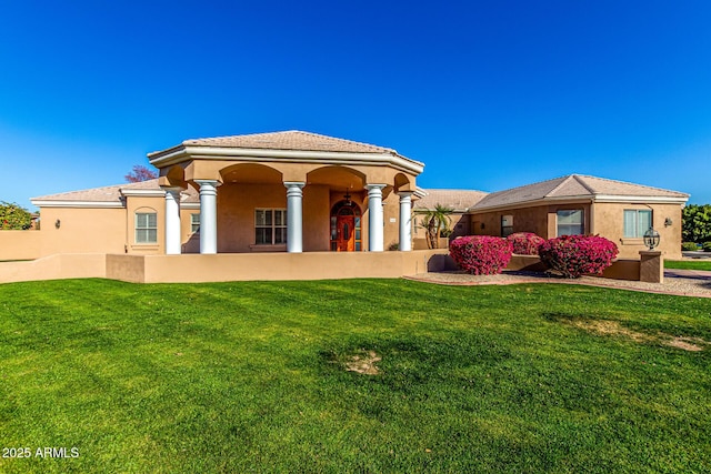 mediterranean / spanish-style house featuring a front lawn