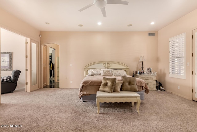 bedroom featuring light carpet and ceiling fan