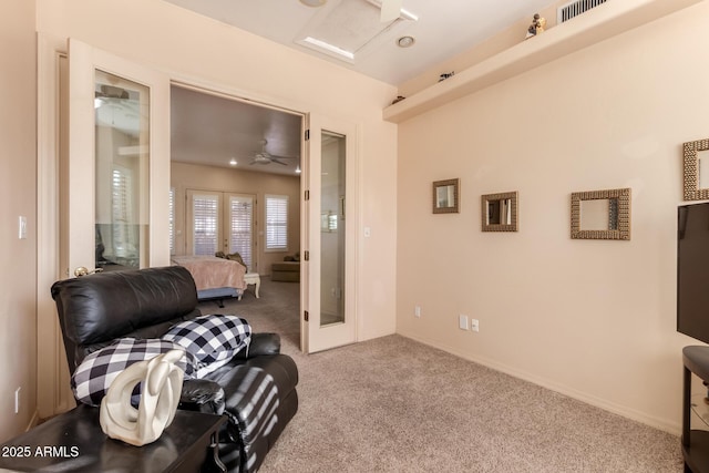 living area with ceiling fan, french doors, and carpet flooring