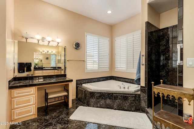 bathroom featuring shower with separate bathtub and vanity