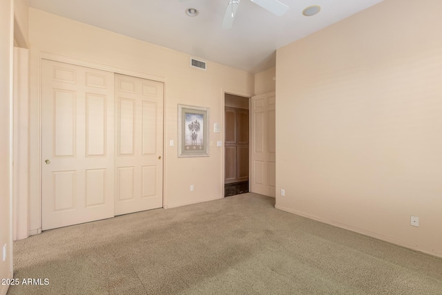 unfurnished bedroom with ceiling fan, a closet, and carpet flooring