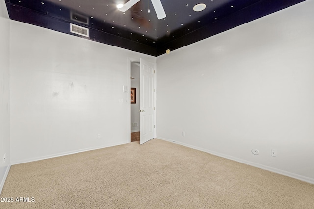 unfurnished room featuring ceiling fan and carpet floors