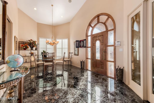 foyer entrance featuring a high ceiling and a notable chandelier