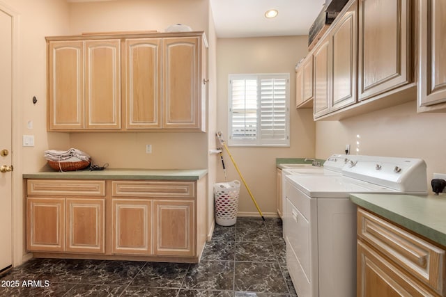 laundry area featuring cabinets and washing machine and clothes dryer