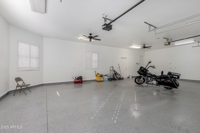 garage with ceiling fan and a garage door opener