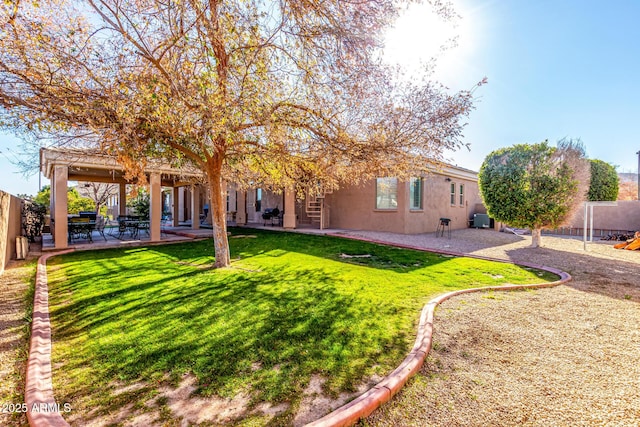 rear view of house featuring a lawn and a patio area