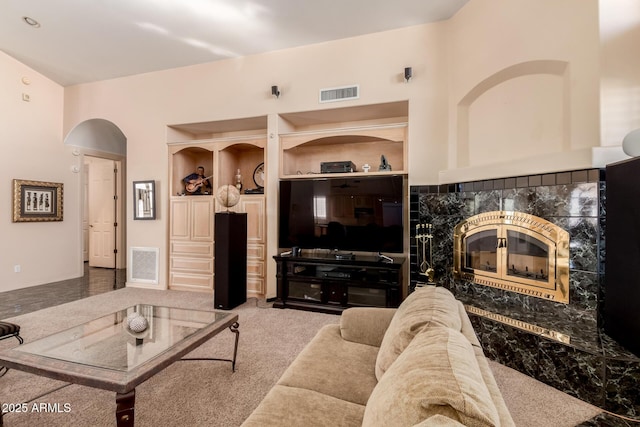 carpeted living room featuring a premium fireplace