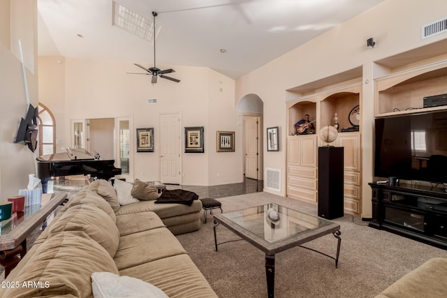 living room featuring built in features, carpet floors, ceiling fan, and a high ceiling