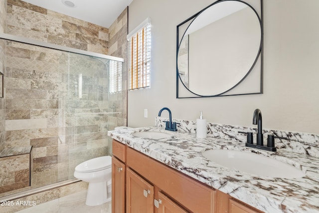 bathroom with toilet, an enclosed shower, and vanity