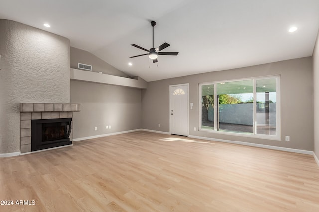 unfurnished living room with a fireplace, vaulted ceiling, light hardwood / wood-style flooring, and ceiling fan