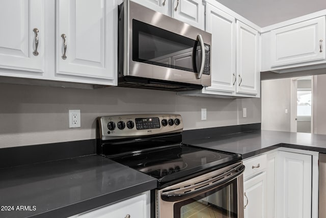 kitchen with white cabinets and appliances with stainless steel finishes