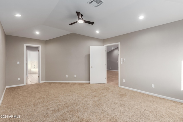 empty room featuring ceiling fan and light carpet