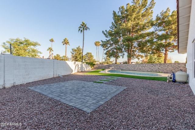 view of yard with a fenced in pool and a patio