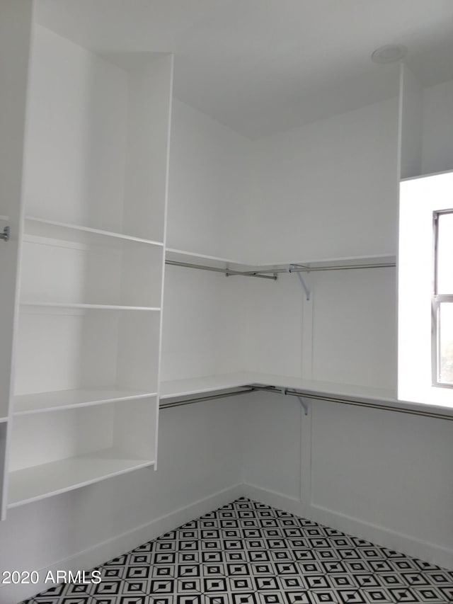 walk in closet featuring tile floors