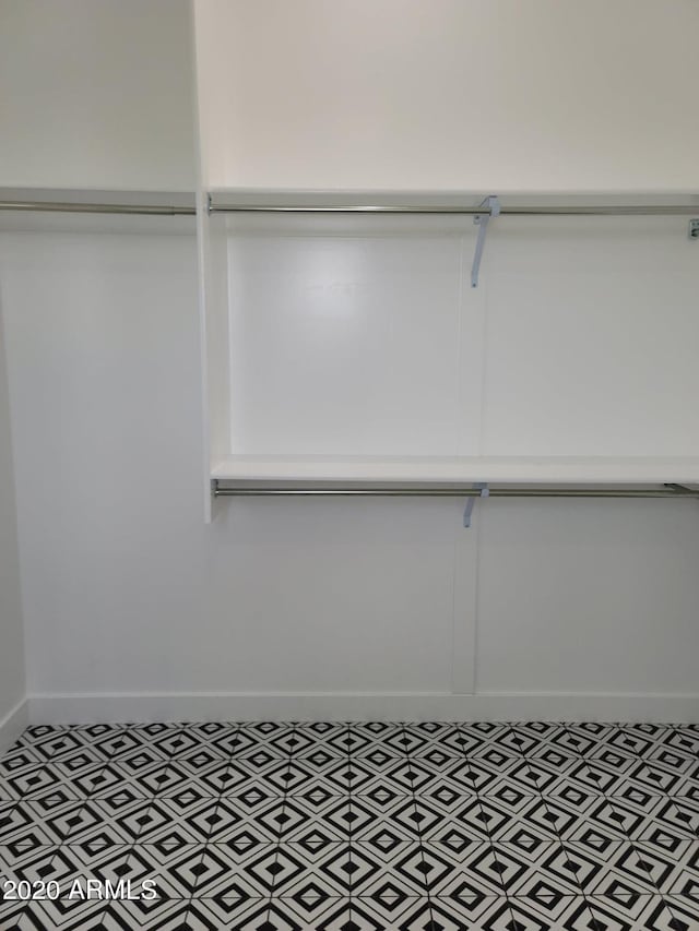 walk in closet featuring tile flooring