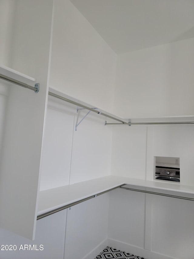 spacious closet with tile flooring