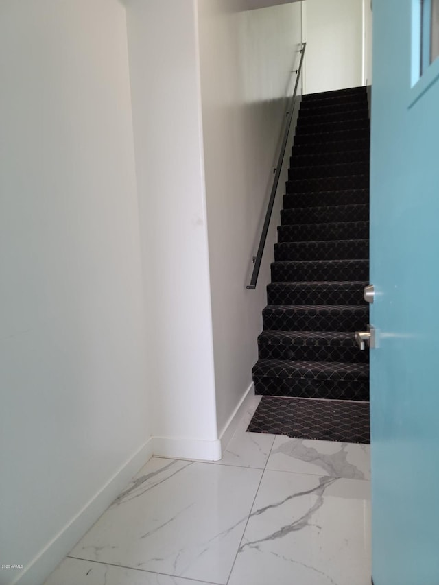 staircase featuring light tile floors