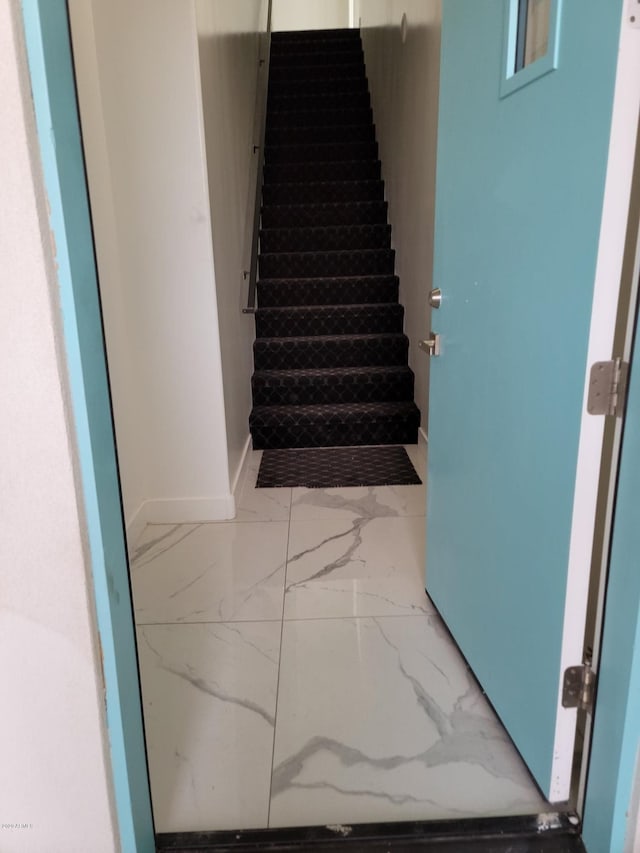 staircase featuring light tile floors