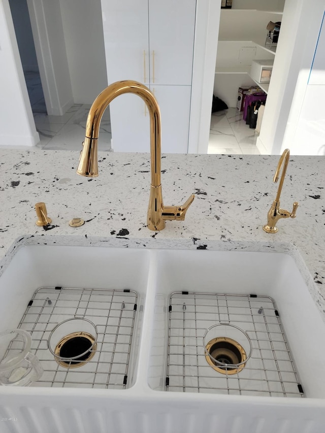 interior details with sink and light tile flooring